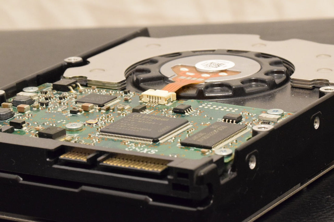 A close-up of an internal hard drive showing its circuit board and cooling fan.