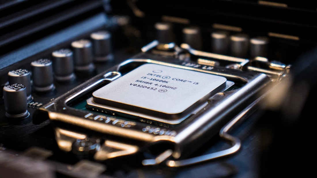 Close-up view of an Intel Core i5 processor installed in a motherboard with surrounding capacitors.
