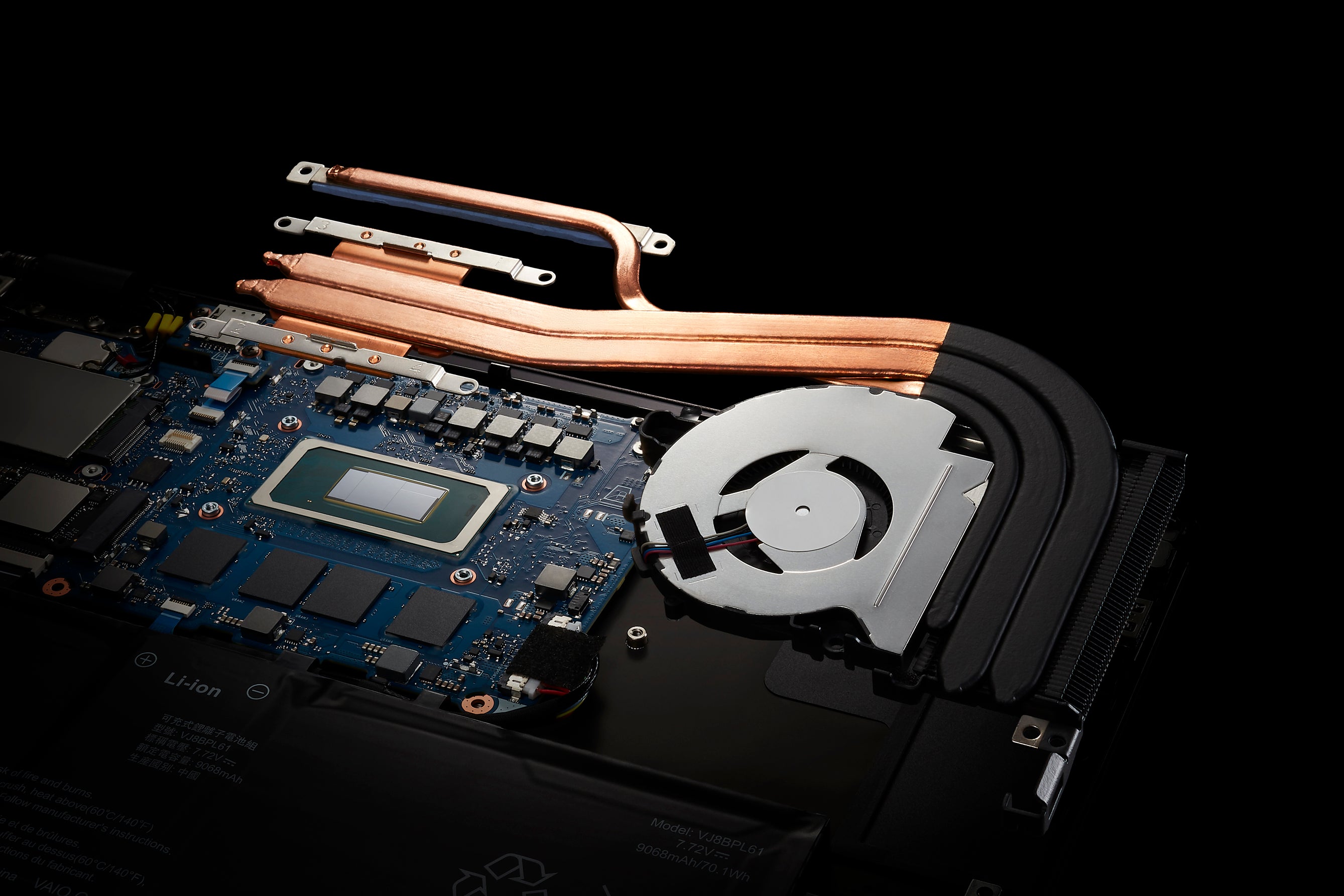 The internal cooling system of a laptop, showing the heat pipes and fan responsible for cooling.