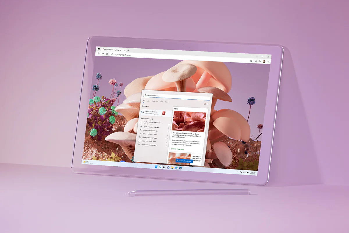 Tablet with a stylus displaying a vibrant screen with Windows interface, set against a soft pink background.