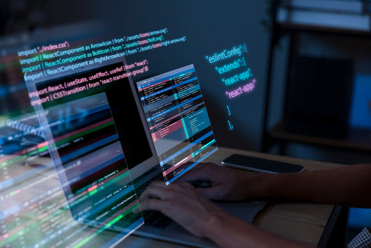 A person coding on a laptop with lines of code displayed on the screen, possibly related to ReactJS.